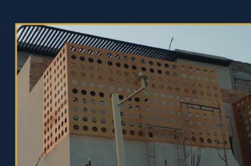 Decorative metal screen installation on building facade